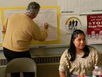 Temp worker & CCT member Juana Garcia looks on as EDA's Signs MOU Temp worker & CCT member Juana Garcia looks on as EDA's Signs MOU
